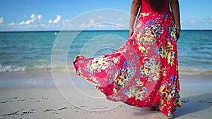 Happy woman in tropical dress enjoys her summer vacation in the Caribbean islands