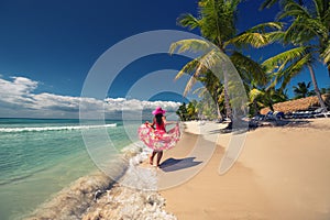 Happy woman on the tropical sandy beach, Saona island, Dominican
