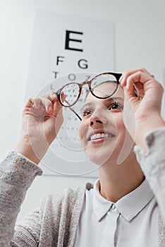 Happy woman trying her new glasses photo