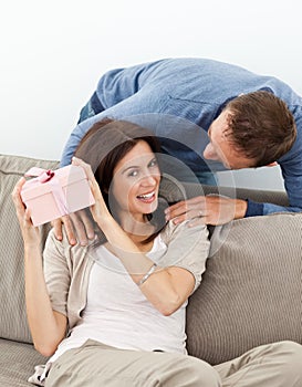 Happy woman trying to guess her present photo