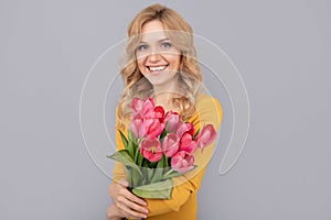 happy woman with tulips. lady hold flowers for spring holiday. happy girl with bouquet