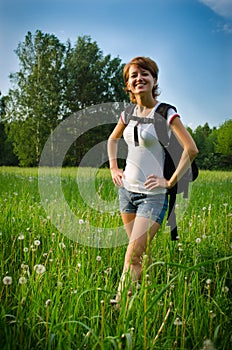 Happy woman turist in a summer field