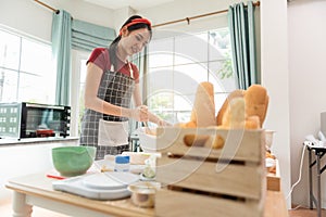 Happy woman use fresh natural products flour milk eggs kneading dough for pastries cookies by hands at modern kitchen