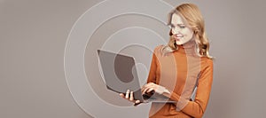 Happy woman use modern laptop computer technology grey background, internet surfing. Woman portrait, isolated header