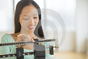 Happy Woman Using Balance Weight Scale