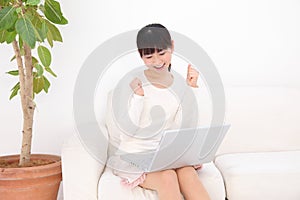 Happy woman using laptop