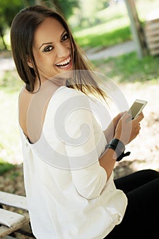 Happy woman using mobile phone