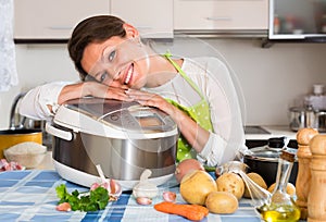 Happy woman using slo-cooker