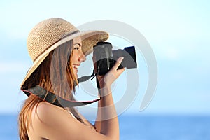 Happy woman on vacation photographing with a dslr camera