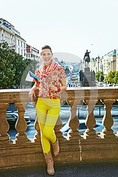 Happy woman on Vaclavske namesti in Prague with Czech flag