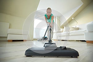 Happy woman with vacuum cleaner at home