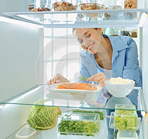 Happy Woman With Vegetables In Front Of Open Refrigerator, selective focus