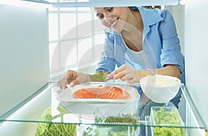 Happy Woman With Vegetables In Front Of Open Refrigerator, selective focus