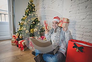 Happy woman on video call celebrating Virtual christmas with family online at home in lockdown