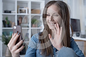 Happy woman on video chat with phone at home
