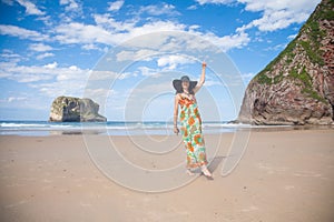 Happy woman vintage dress dancing at beach