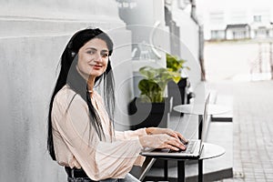 Happy woman with vitiligo skin pigmentation on hands working on laptop and listen music. Lifestyle with skin seasonal