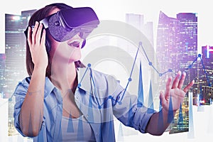 Happy woman in VR glasses using digital graph