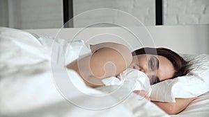 Happy Woman Waking Up In Comfortable Bed With White Linens