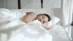 Happy Woman Waking Up In Comfortable Bed With White Linens