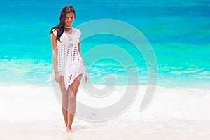 Happy woman walking on beach