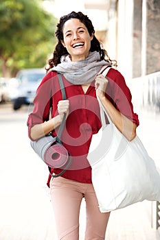 Happy woman walking to her yoga lesson