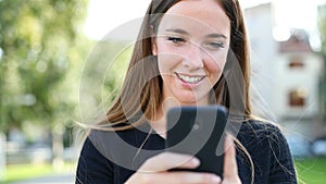 Happy woman walks using a smart phone