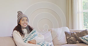 Happy woman in warm clothing sitting on sofa watching television 4K 4k