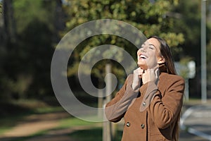 Happy woman warmly clothed in winter breathing fresh air photo