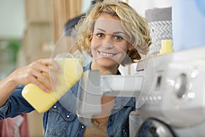 Happy woman washes washing machine