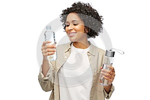 happy woman with water in glass and plastic bottle