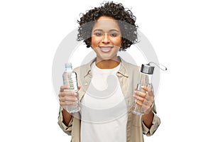 happy woman with water in glass and plastic bottle