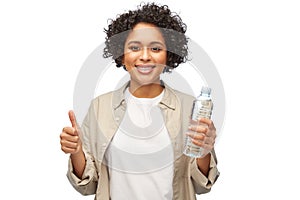 happy woman with water in plastic bottle