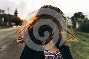 Happy woman waving hair in sunlight summer sunset. moment of car