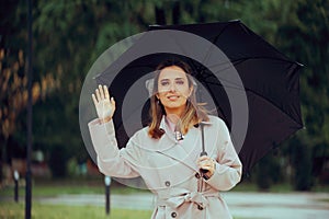 Happy Woman Waving Hello Holding an Umbrella