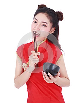 Woman wearing chinese cheongsam dress with chopsticks and bowl i