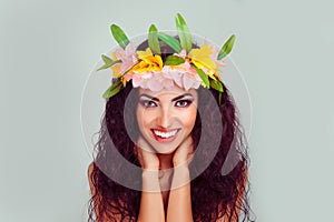 Happy woman wearing floral headband  and bright makeup isolated on light green background