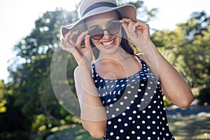 Happy woman wearing sunglasses and hat