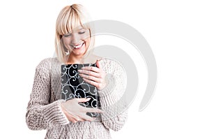 Happy woman wearing warm sweater holding a present