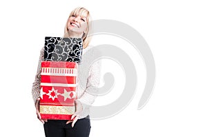 Happy woman wearing warm sweater holding presents