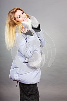 Happy woman wearing winter warm furry jacket