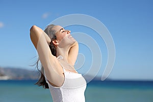 Happy woman in white dres breathing with waxed armpit