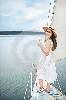 Woman with glass of champagne resting on boat