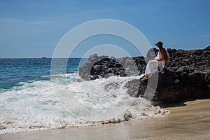 Happy  woman in white dress on tropical beach vacation