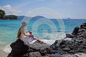 Happy  woman in white dress on tropical beach vacation