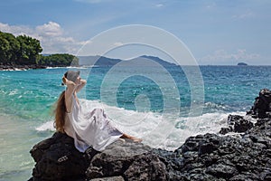 Happy  woman in white dress on tropical beach vacation