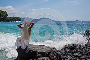 Happy  woman in white dress on tropical beach vacation