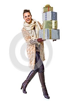 Happy woman on white with pile of Christmas giftes walking