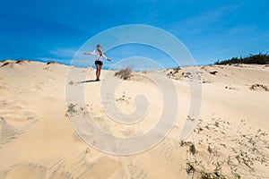 Happy woman on White sand dunes in Vietnam