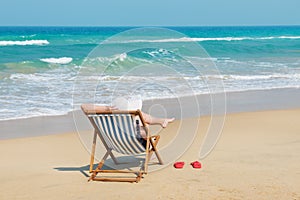 Happy woman in white sunhat on the beach